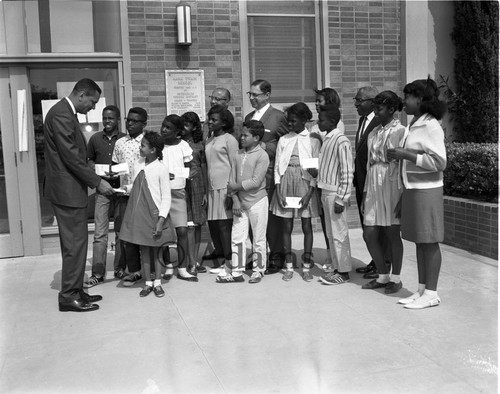 Greeting school children, Los Angeles, 1964