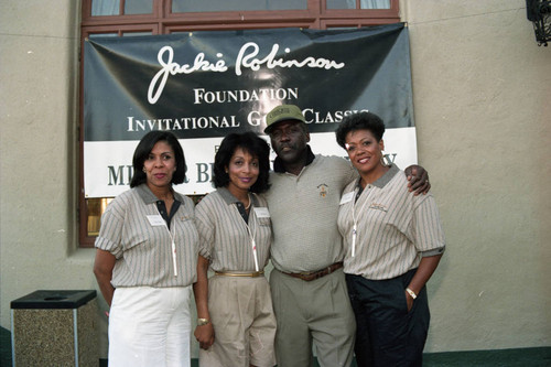 Richard Roundtree posing with others at the Jackie Robinson Foundation Gold Classic, Los Angeles. 1994