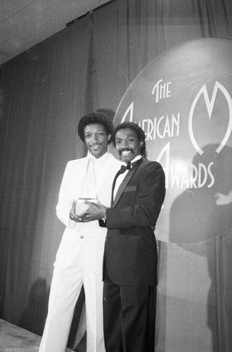 James "J. T." Taylor and Robert "Kool" Bell posing with their American Music Award, Los Angeles, 1983