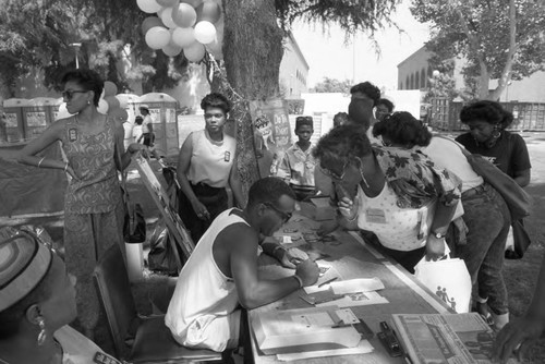 People visiting an exhibitor during the Black Family Reunion, Los Angeles, 1989