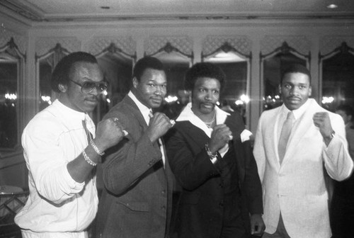 Michael Dokes, Larry Holmes, Mike Weaver, and Tim Weatherspoon posing together at a press conference for the "Crown Affair" boxing event, Los Angeles, 1983