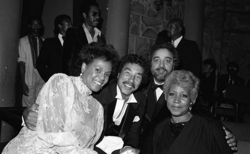 Aretha Franklin, Smokey and Claudette Robinson, and Danny Bakewell posing together, Los Angeles, 1983