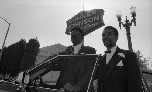 Men posing in front of Conner-Johnson Funeral Home, Los Angeles, 1983