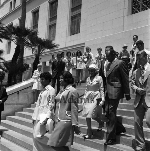 Tom and Ethel Bradley walking down the steps of City Hall during inauguration ceremonies, Los Angeles, 1973