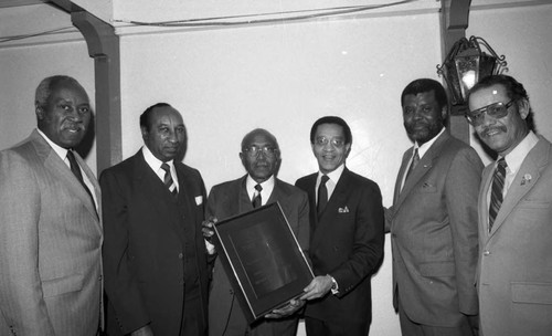 Crenshaw Chamber of Commerce members presenting a plaque, Los Angeles, 1987