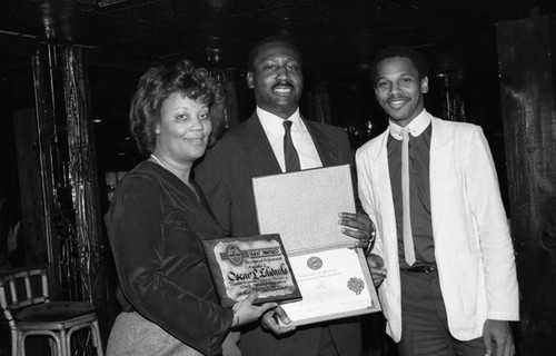 Oscar L. Edwards holding an award, Los Angeles, 1986