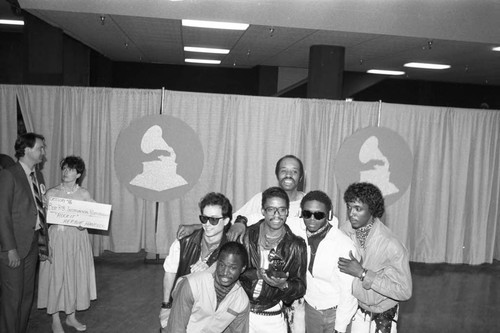 Herbie Hancock posing with his Grammy and band members at the 26th Annual Grammy awards, Los Angeles, 1984