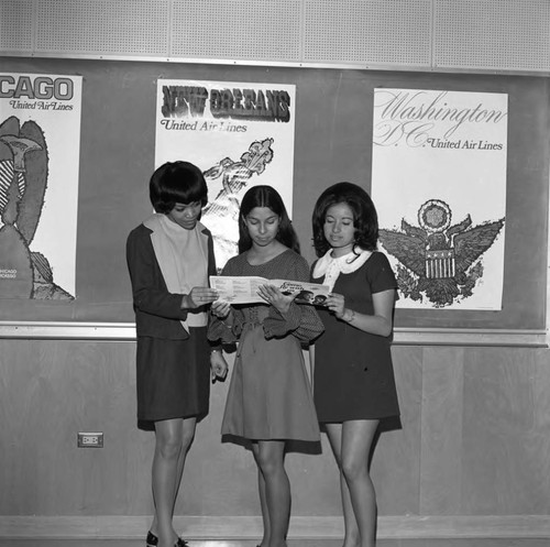 Women look at Brochure, Los Angeles, 1971