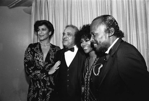 Jayne Kennedy, Benjamin Hooks, Cicely Tyson, and Miles Davis standing together at the NAACP Image Awards, Los Angeles, 1981