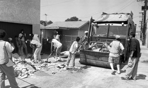 People Who Care Youth Center participants cleaning an alley, Los Angeles, 1989