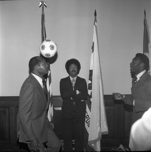 Mayor Tom Bradley balancing a soccer ball during a visit from Pelé, Los Angeles, 1975