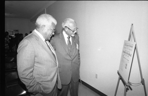 Rev. James Lawson and Rev. Thomas Kilgore examining a poster during a Southern Christian Leadership Conference event, Los Angeles, 1989