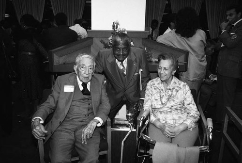 Dr. H. Claude Hudson posing with others during his 98th birthday celebration, Los Angeles, 1984