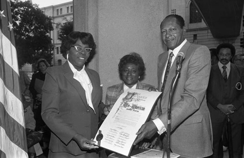 Tom Bradley and others with a Black History Month proclamation, Los Angeles, 1982