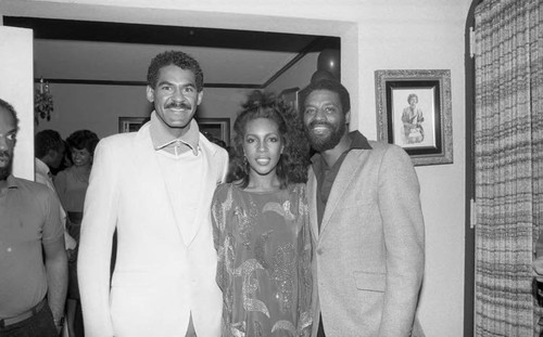 Mary Wilson posing with guests at her birthday party, Los Angeles, 1985