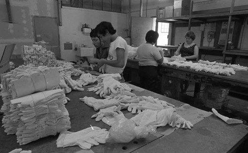 Employees sorting white gloves in a workshop, Los Angeles, 1979