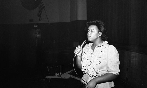 Young woman singing in a talent show at Dorsey High School, Los Angeles, 1983