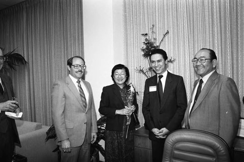 Paul C. Hudson posing with guests of a Broadway Federal Savings and Loan event, Los Angeles, 1984