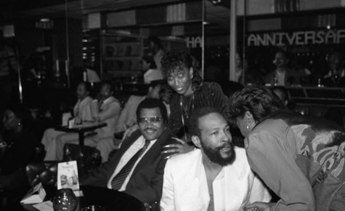 Marvin Gaye sitting with others at the Pied Piper nightclub, Los Angeles, 1983