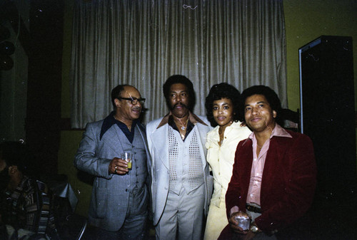 Herb and Connie Thompson posing with guests at their Super Bowl party, Los Angeles, 1977