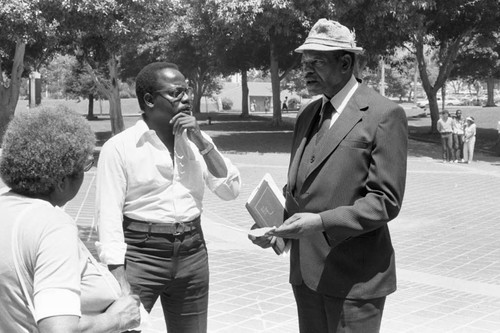 Rev. Bill Minson talking with a man near L.A. City Hall, Los Angeles, 1983