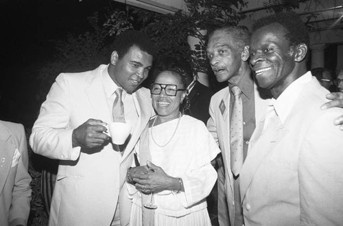 Muhammad Ali talking with guests of an Olympic Arts Festival cast party, Los Angeles, 1984