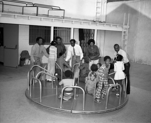 Cosmos Social Club members watching children play at the International Children's School, Los Angeles, 1974