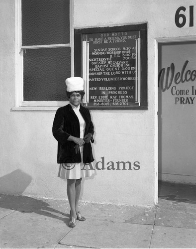 Woman standing next to church board, Los Angeles, 1979