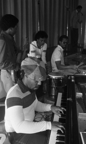 Musicians accompanying a man singing on stage, Los Angeles, 1983