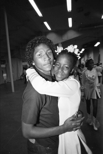 Locke High School drill team member sharing a hug, Los Angeles, 1983