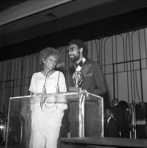 Unidentified man receiving an award from Maggie Hathaway at the NAACP Image Award, Los Angeles, 1978