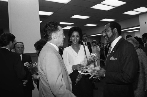 Elbert T. Hudson talking with an unidentified couple, Los Angeles, 1984