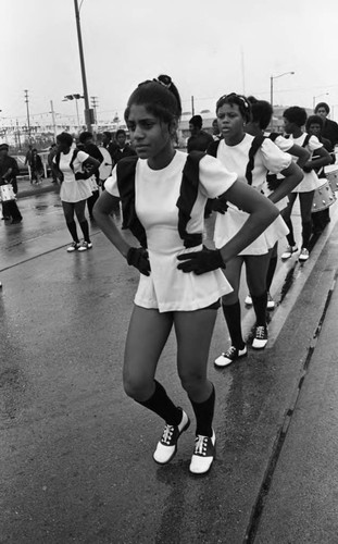 Drill team members marching in the Compton Christmas Parade, Compton, 1983