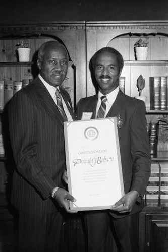 Donald Bohana receiving an award from Nate Holden, Los Angeles, 1983