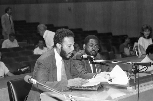 Mark Ridley-Thomas listening as a man speaks during a meeting, Los Angeles, 1985