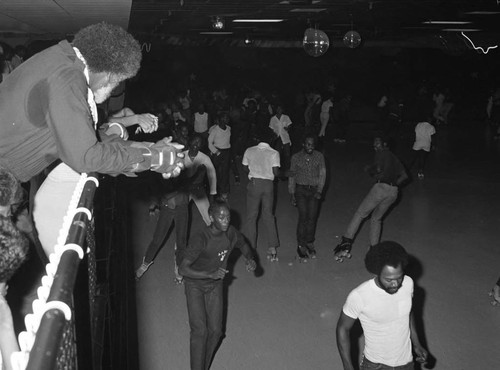 Men and women skating at World on Wheels, Los Angeles, 1983