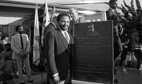 Martin Luther King III standing next to a plaque at Darby Park, Los Angeles, 1984