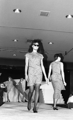 Models walking the runway during a fashion show at California Mart, Los Angeles, 1985