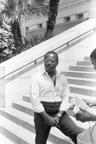 Rev. Bill Minson posing on the steps of L.A. City Hall, Los Angeles, 1983