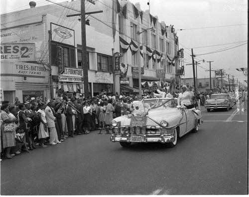 Elks members riding in a convertible during a procession, 1956