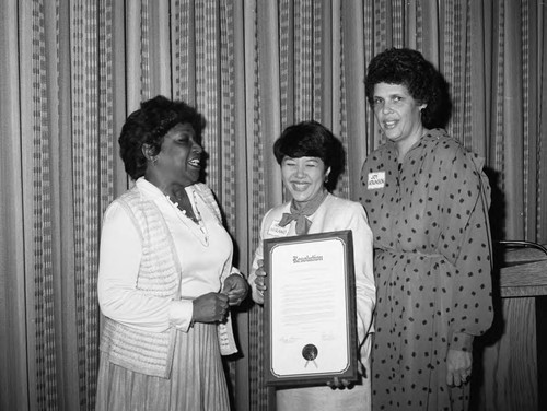 Irene Hirano displaying a resolution at The Clinic's 10th anniversary celebration, Marina del Rey, 1984