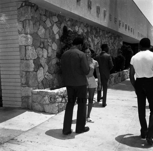 Ali chats with unidentified woman, Los Angeles, 1972