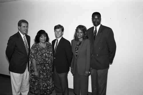 Mary Ann Mitchell and Bill Bickermann posing with others before a business conference, Los Angeles, 1994