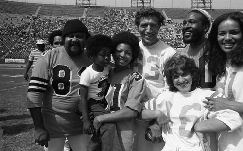 Participants of the Urban League's Celebrity All-Star Freedom Classic pre-game posing together, Los Angeles, 1973