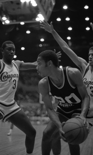 Crenshaw basketball players blocking a Banning player's pass during the city tournament, Los Angeles, 1983