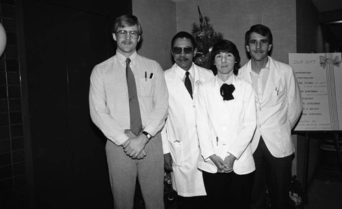 Christopher C. Dotson posing with others during a health care screening event, Los Angeles, 1984