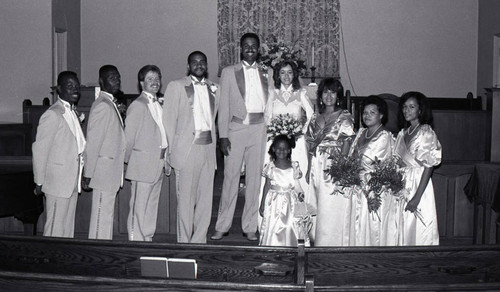 Dredra Daniels posing with her husband and wedding party, Los Angeles, 1986