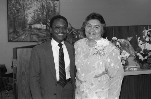 Man and woman posing together during a retirement party, Los Angeles, 1985