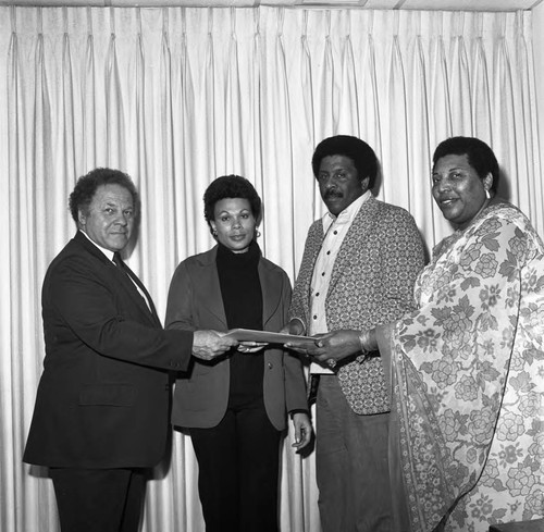 Group posing with an envelope, Los Angeles, 1978