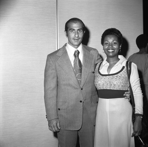 Bob Moretti posing with a woman at the California Black Elected Officials Conference, Los Angeles, 1973